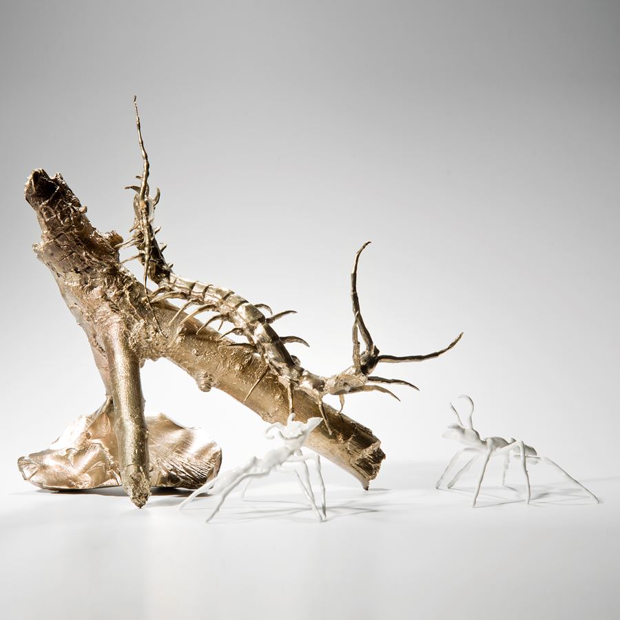 artwork of bronze centipede with glazed porcelain ants.