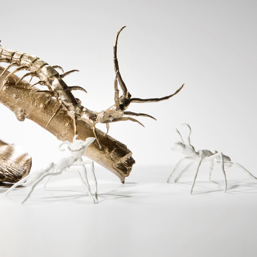 artwork of bronze centipede with glazed porcelain ants.