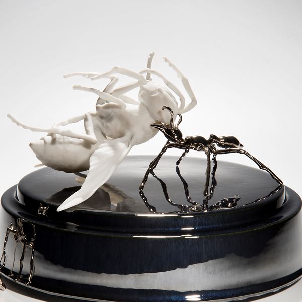 ceramic and metal sculpture of hornet and ants on round base