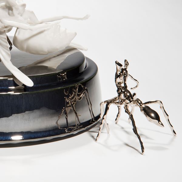 ceramic and metal sculpture of hornet and ants on round base