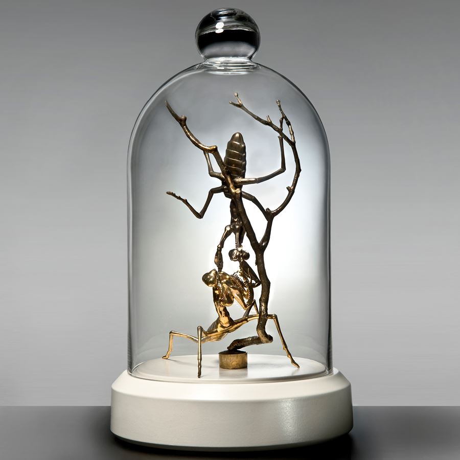 metal glass and porcelain sculpture of ants trapped in tall dome
