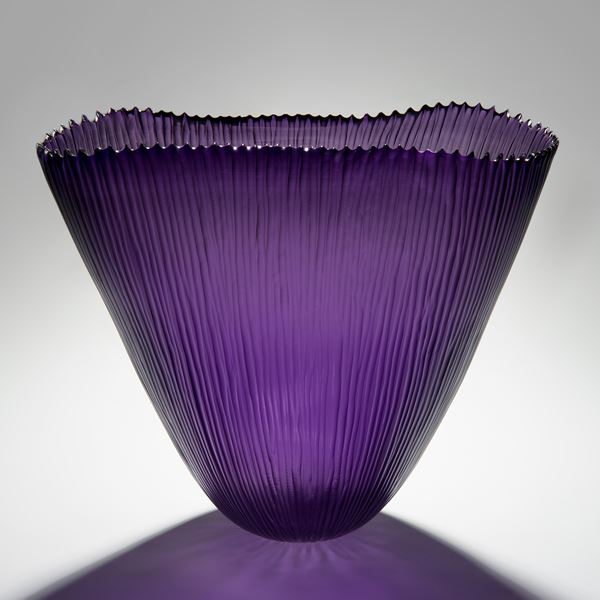 purple hand cut glass sculptre of wide open top basket with ribbed edge