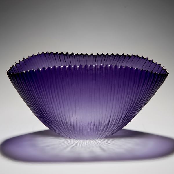 decorative art glass bowl with ribbed texture in purple