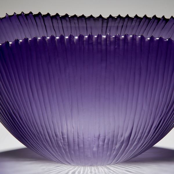 decorative art glass bowl with ribbed texture in purple