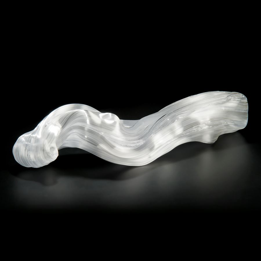 experimental art glass sculpture of long curved form in white