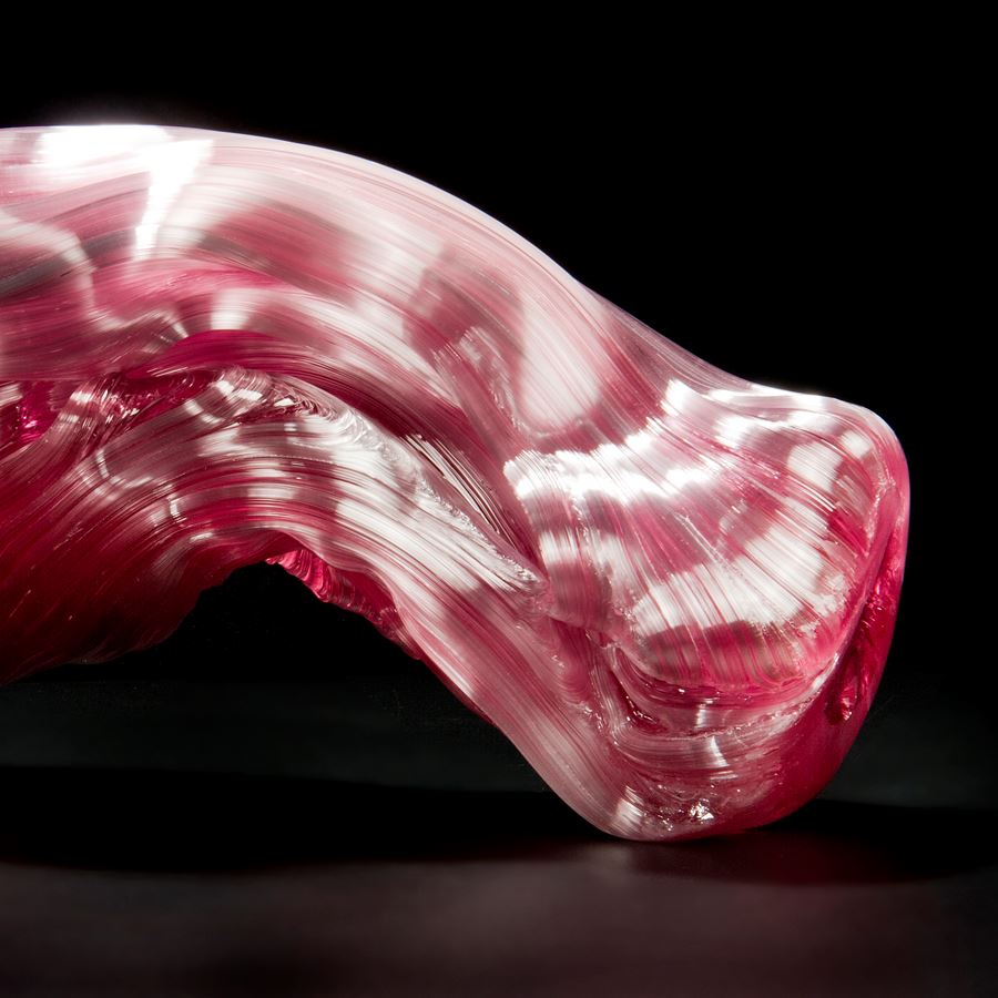 stretched and bent glass formation of abstract sculpture in pink