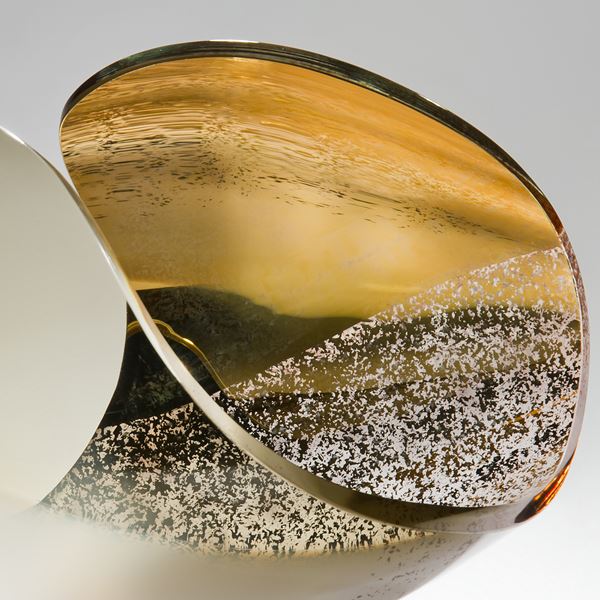 detailed glass sculpture of concave shape in beige bone white and gold