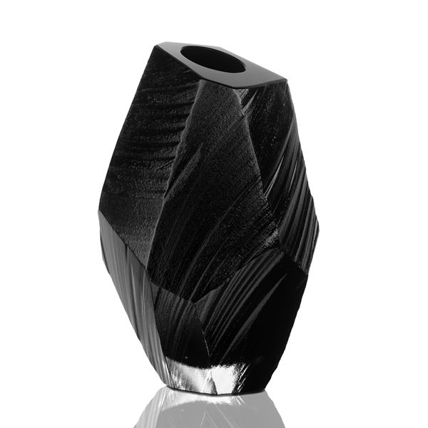black sculped glass vessel artwork resembling space rock 