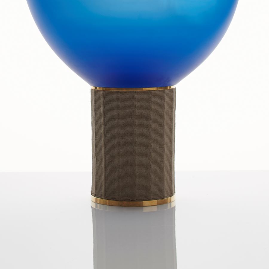 contemporary art glass sculpture resembling lightbulb of blue oval shaped top resting on bronze base