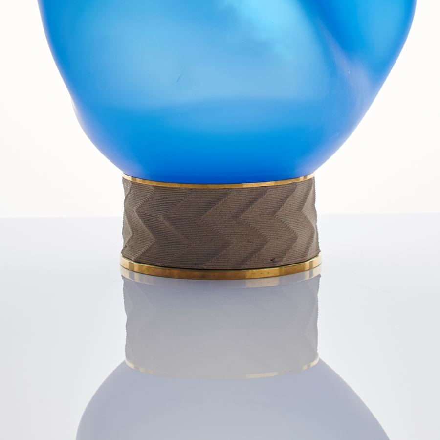 blue art glass sculpture of blob shaped blown glass top with bronze base