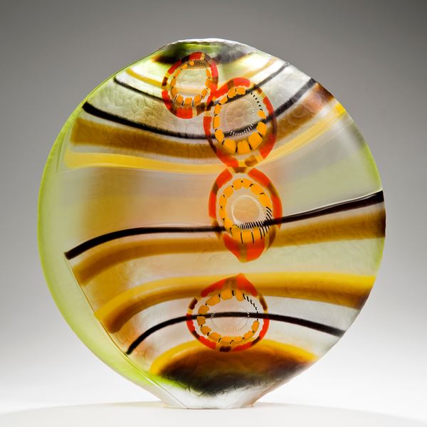 round art glass vase in green brown red and orange