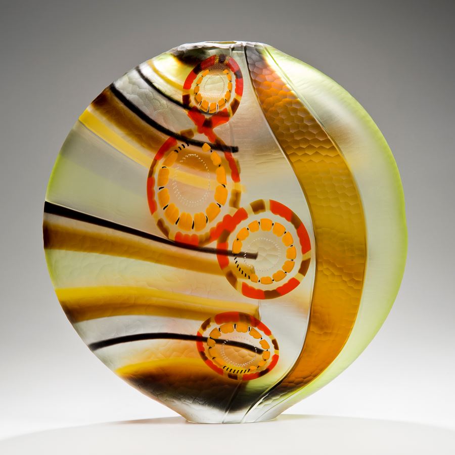 round art glass vase in green brown red and orange