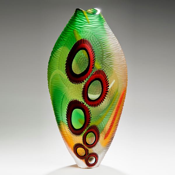 tall bright green art glass vase with red round patterning