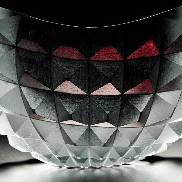 art glass bowl with pyramid stud shaped exterior in red black and white