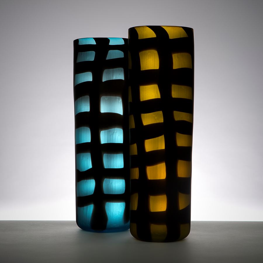 two blown art glass vases in electric blue and dark yellow with black checked pattern