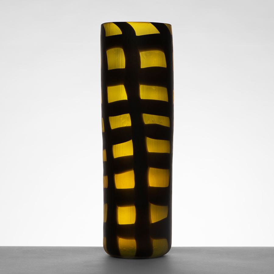 two blown art glass vases in electric blue and dark yellow with black checked pattern