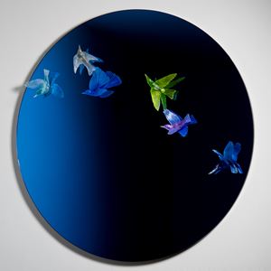 round blue art glass mirror with bird sculptures