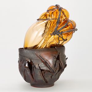 amber glass ornament in teracotta container with copper wire