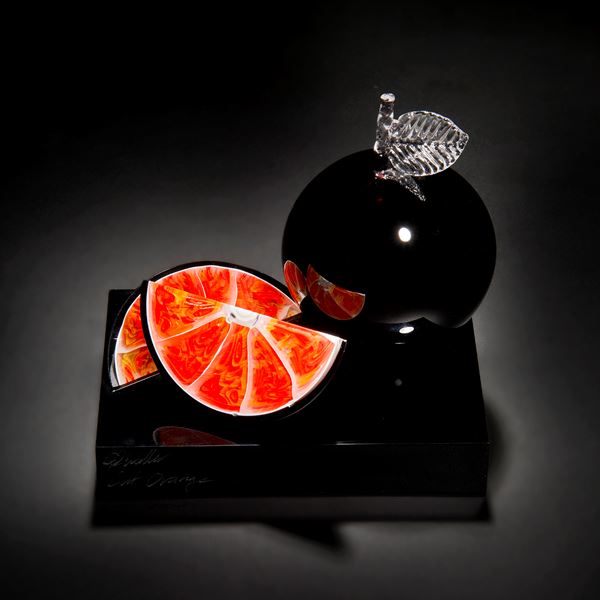 black and orange art-glass sculpture of fruit 