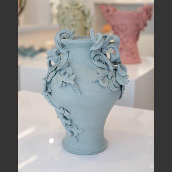 turquoise coloured decorative stoneware vase sculpture with ornate flower trim