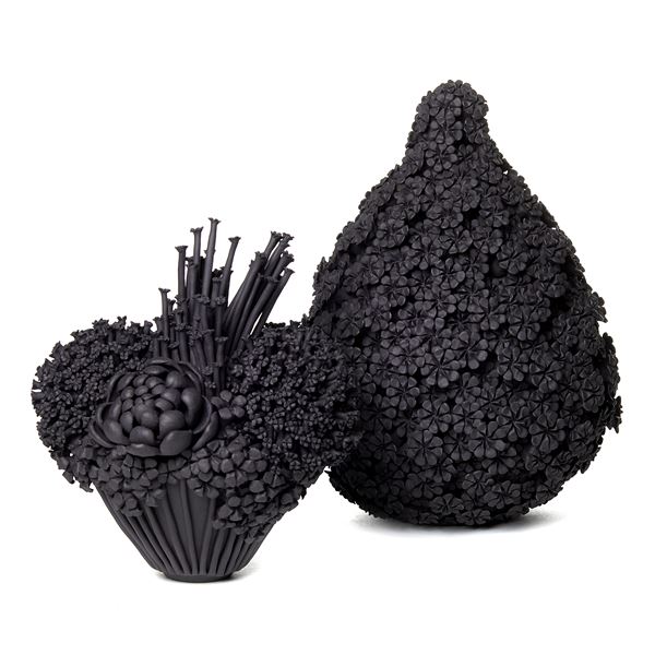 black stoneware teardrop shaped sculpted artwork covered in flowers