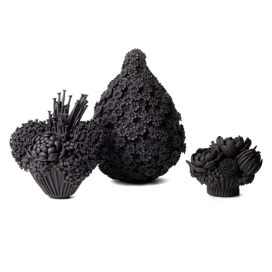 black stoneware teardrop shaped sculpted artwork covered in flowers
