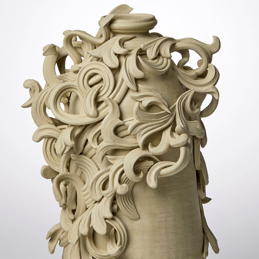 grey decorative stoneware vase sculpture with ornate floral trim
