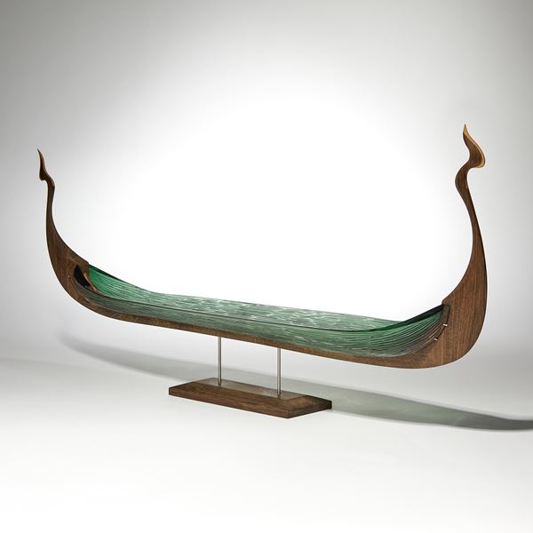 wood and glass sculpture of viking ship in green and brown on wooden base