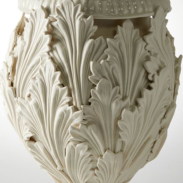 footed ornate vessel with leaf decoration handmade from porcelain