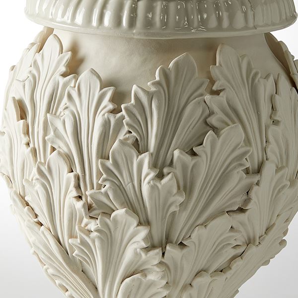footed ornate vessel with leaf decoration handmade from porcelain