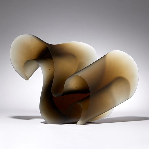 bronze brown fluid lined sculpture with dramatic sweeping curves made from cast glass