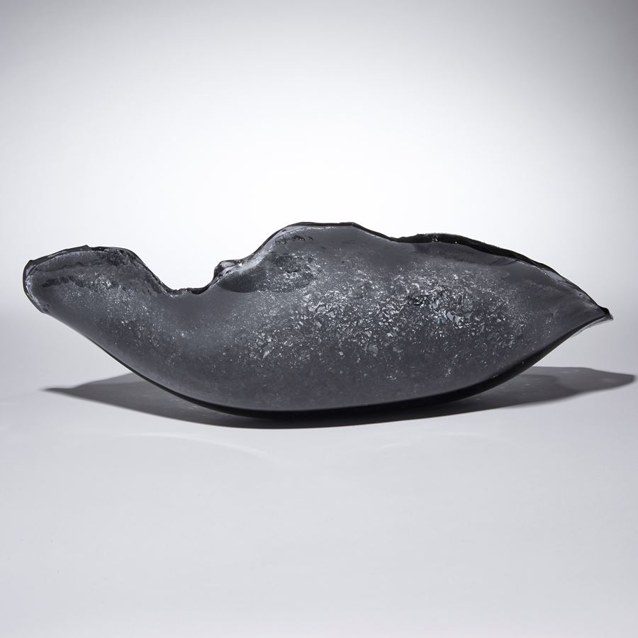 grey and blue oyster shell shaped glass sculpture with a twinkling crystal covered interior