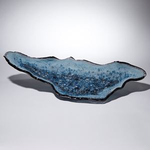 light and dark blue long organically shaped glass sculpture with a twinkling crystal covered interior