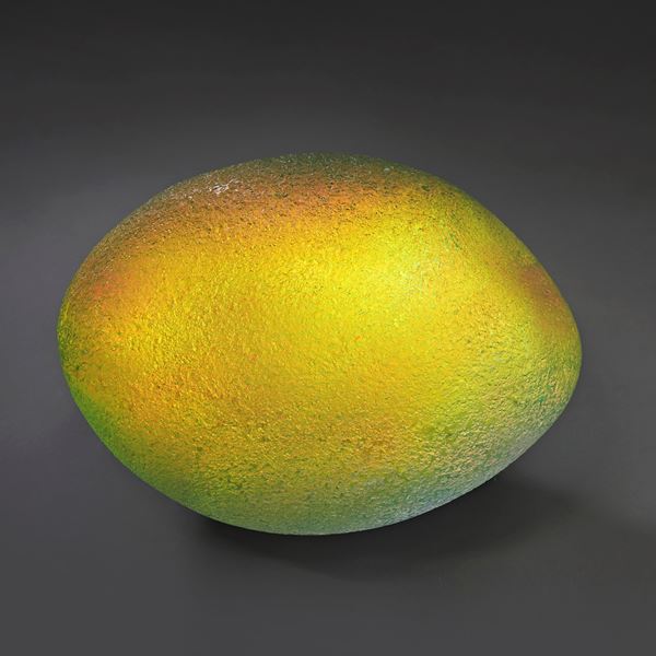 iridescent and gold coloured ovoid handmade glass sculpture with soft rock like texture