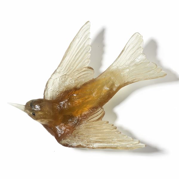 glass sculpture of swallow bird in yellow gold