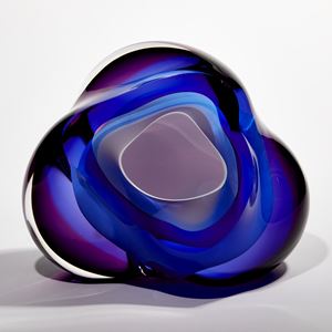 layers of white blue and purple glass create an amorphous handmade sculpture