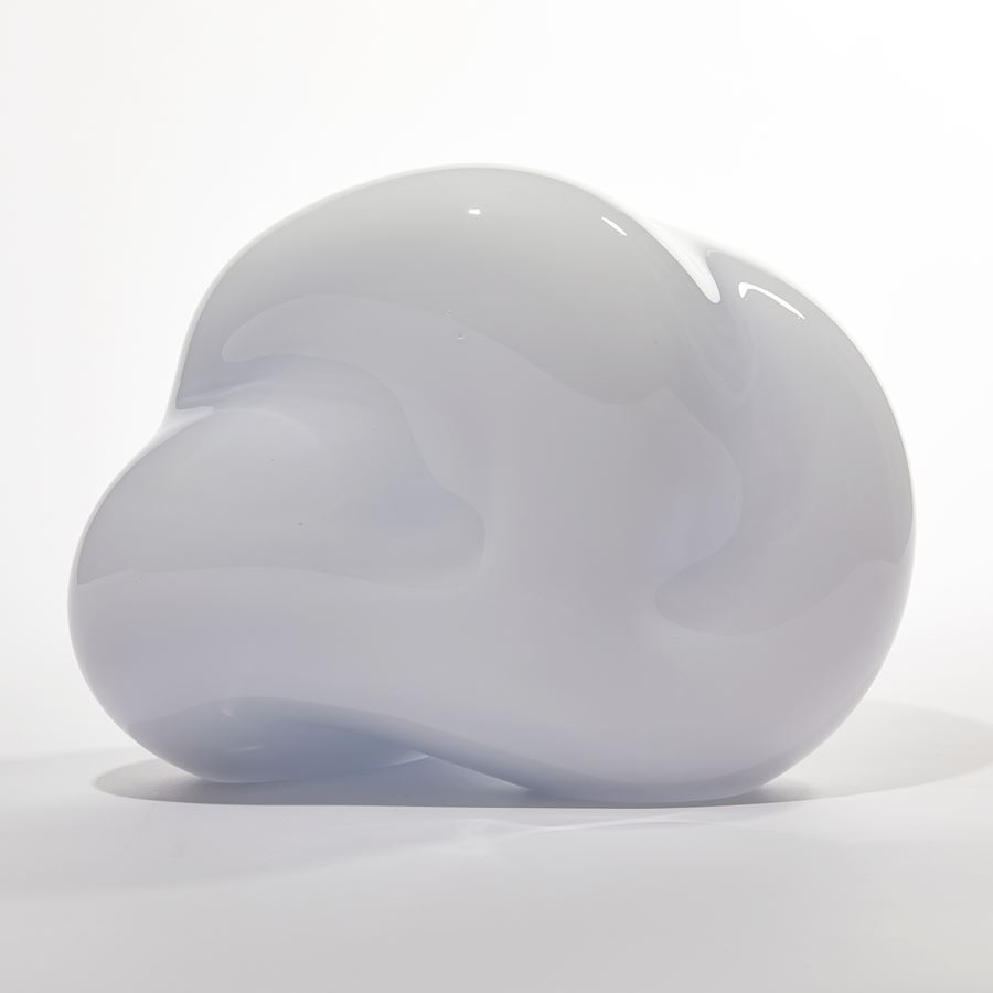 cloud like soft white form with turquoise interior sculpted from blown glass