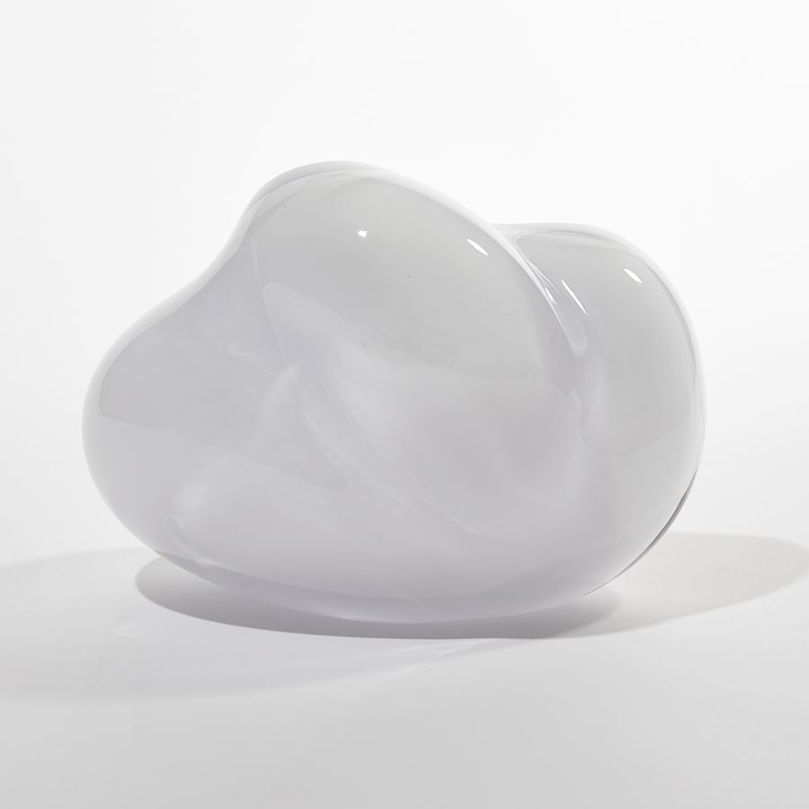 cloud like soft white form with blue interior handmade from blown glass