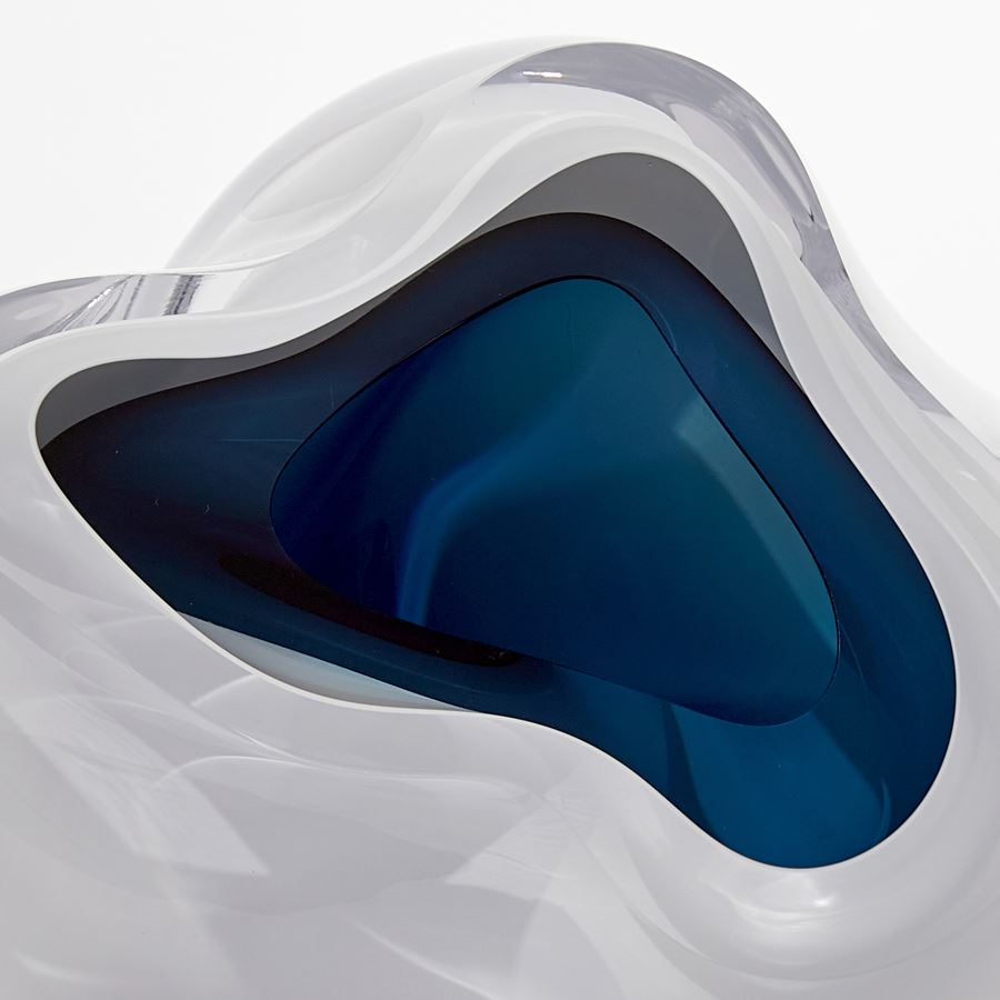 cloud like soft white form with blue interior handmade from blown glass
