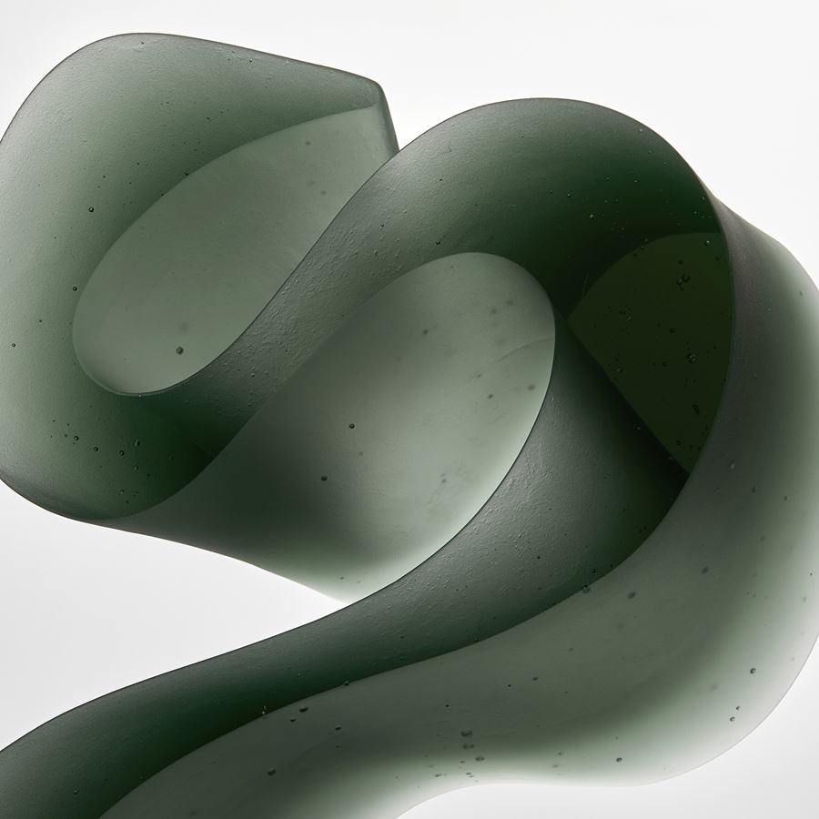 green abstract line sculpture made from cast glass