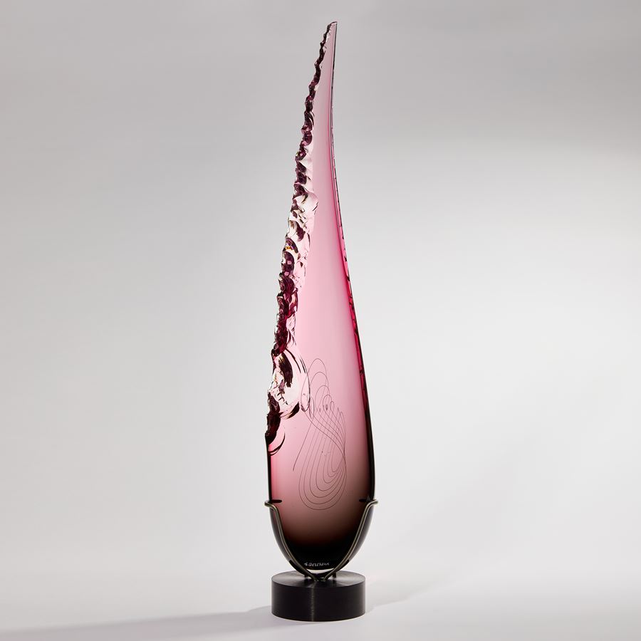 Long teardrop form in pink with one soft edge and chipped detail on the other handmade from glass