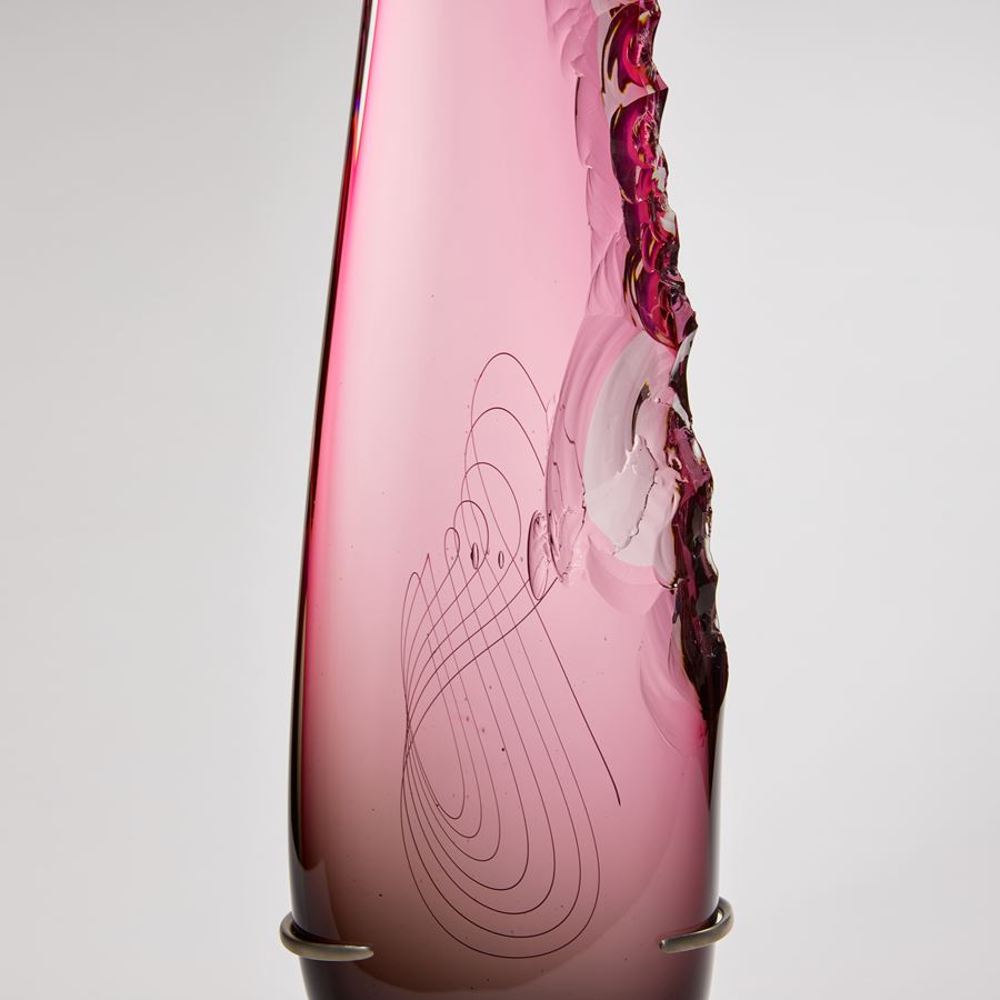 Long teardrop form in pink with one soft edge and chipped detail on the other handmade from glass