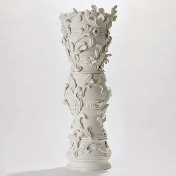 tall ceramic sculptural column covered in organic swirls and flourishes handmade from porcelain