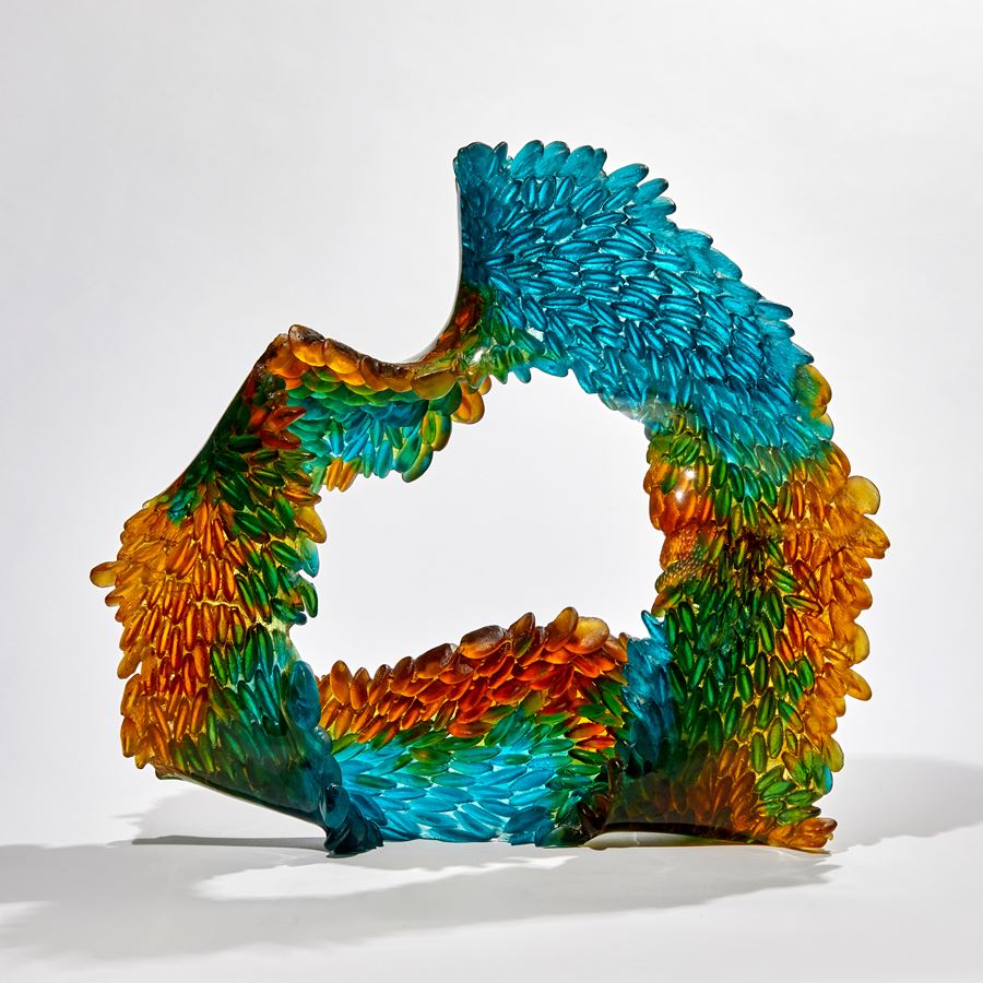 green turquoise and amber continuous ringed scaled sculpture made from glass