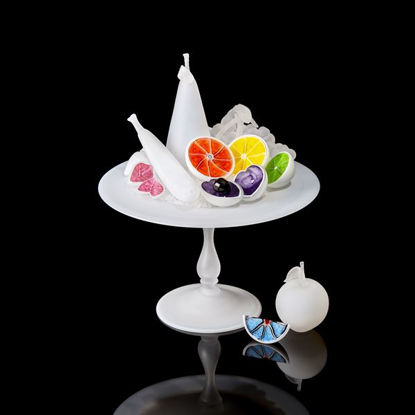 white centrepiece with bisected white fruits each with a different coloured interior handmade from glass