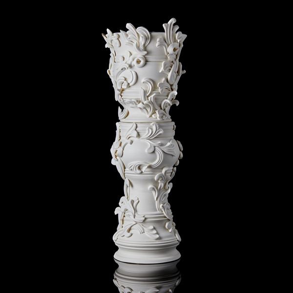 tall ceramic sculptural column covered in organic swirls and flourishes handmade from porcelain