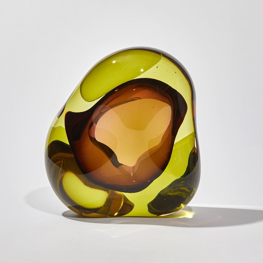 amorphic shaped handmade glass sculpture in lime and purple with centre cavity opening