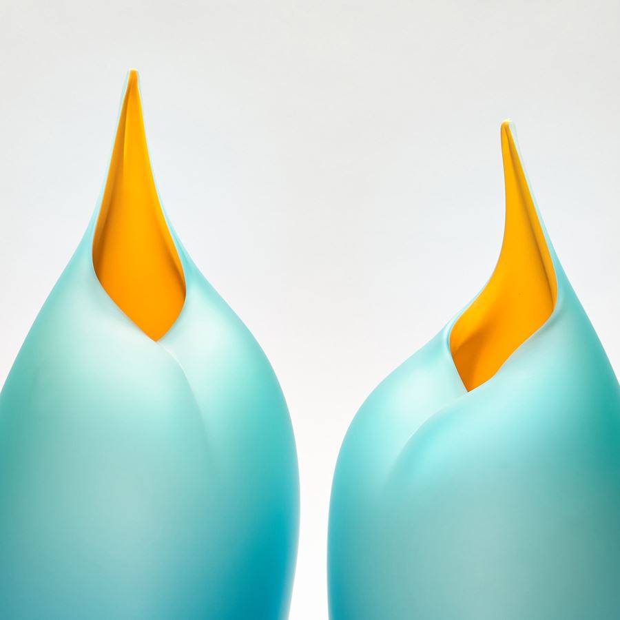 Sleek tall simplified bird form handmade glass sculpture in teal and yellow