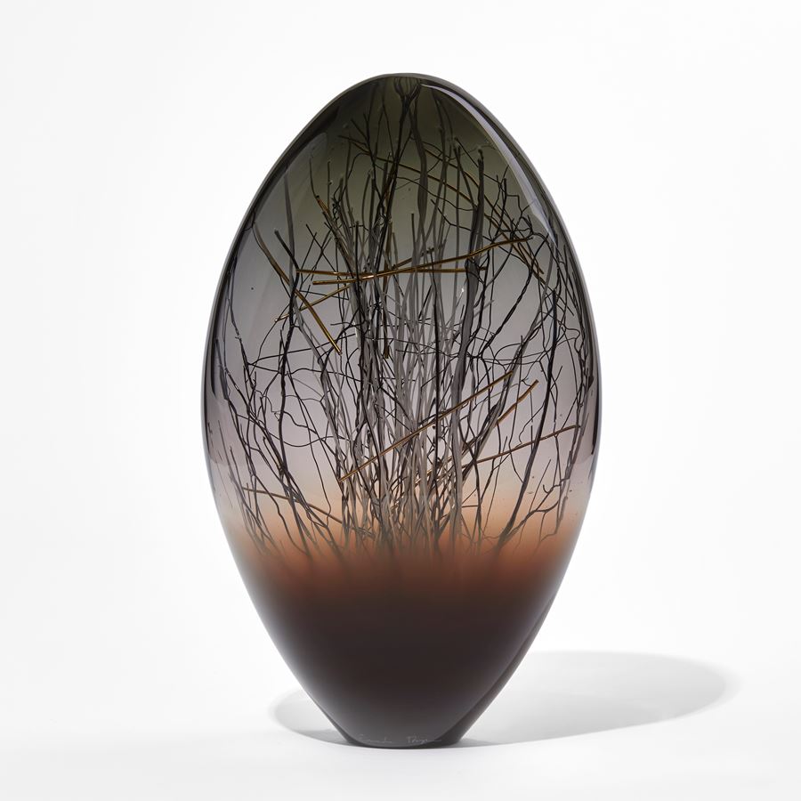 dark brown grey and black ovoid handmade glass sculpture with inner line detail in black and gold