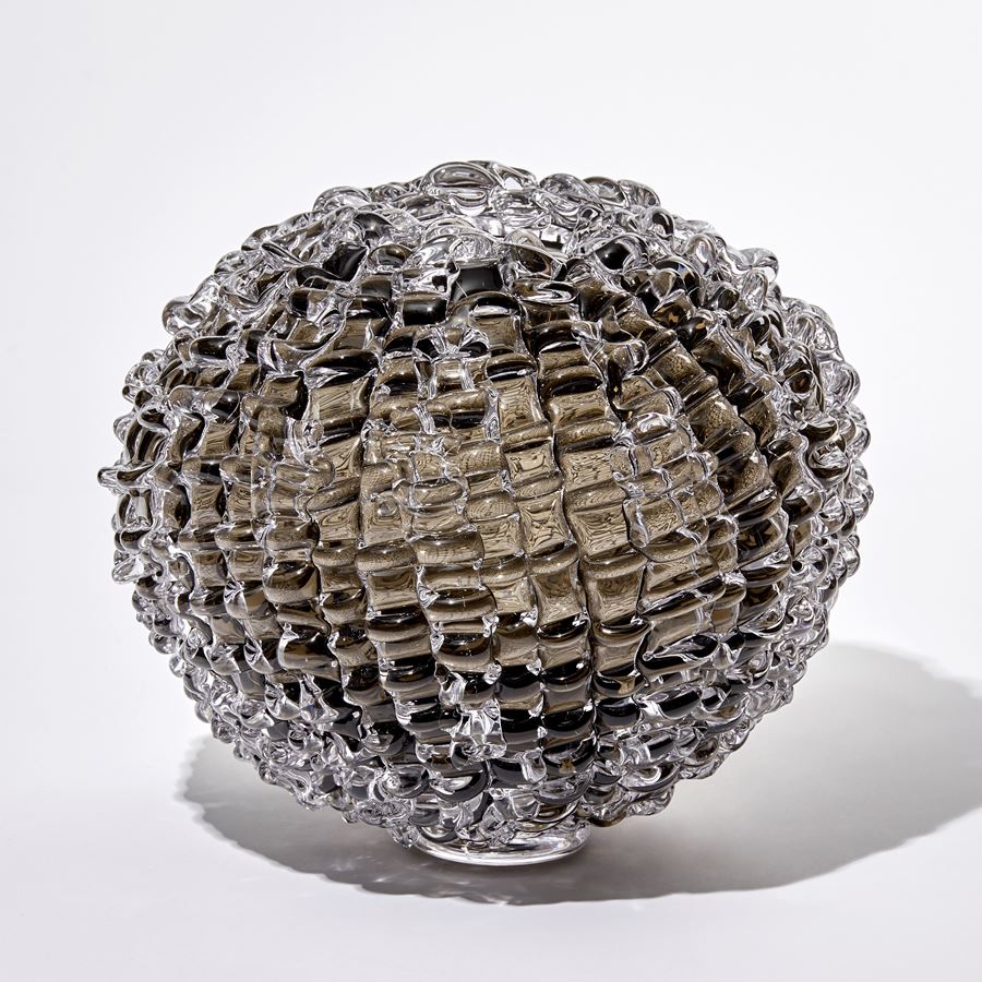 browny grey round handmade glass sculpture with rippled surface